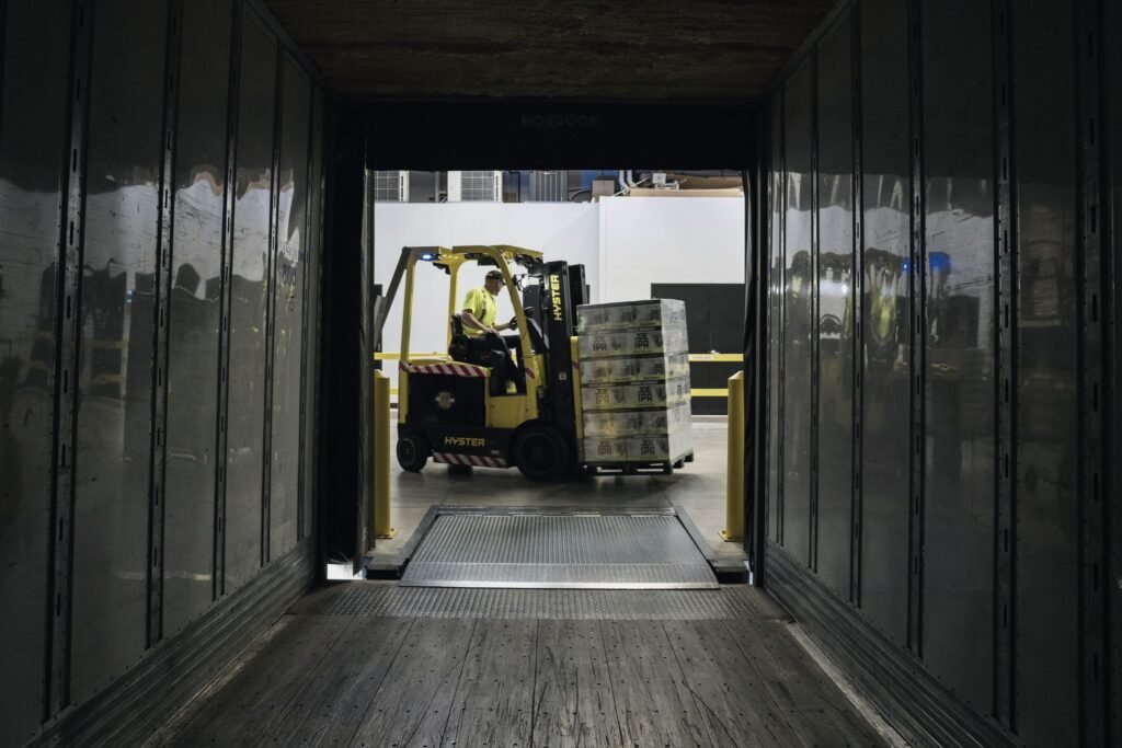 Forklift loading pallets into a trailer