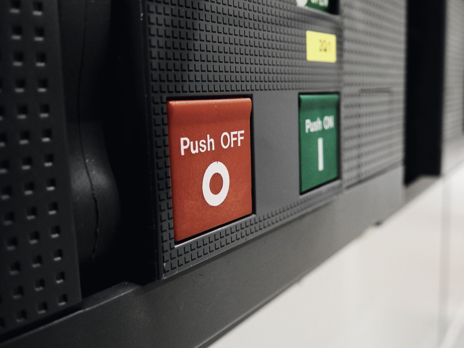 Close-up of a power circuit breaker face with on and off buttons